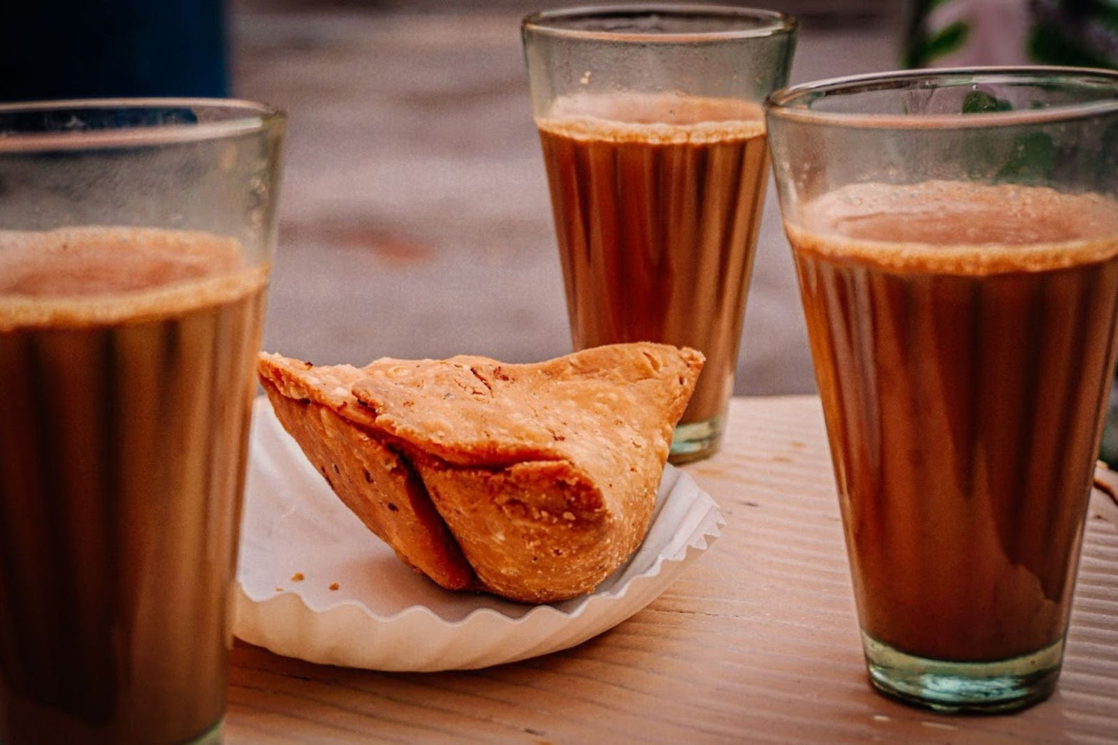 3 Chai glasses along with a Samosa