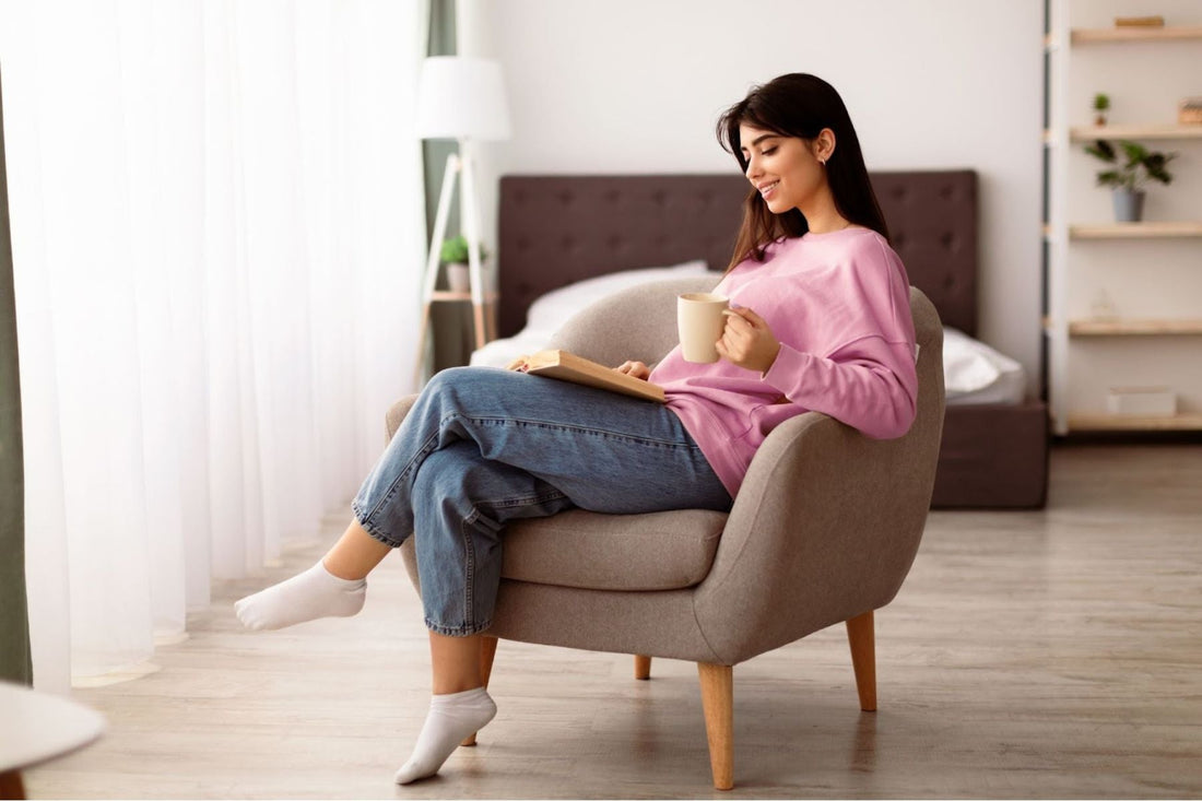 Woman sitting on a couch holding a tea cup