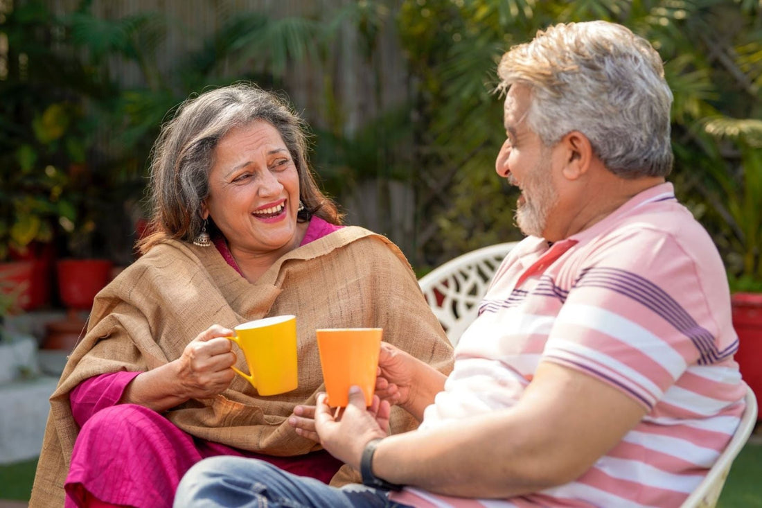 A couple laughing while having tea