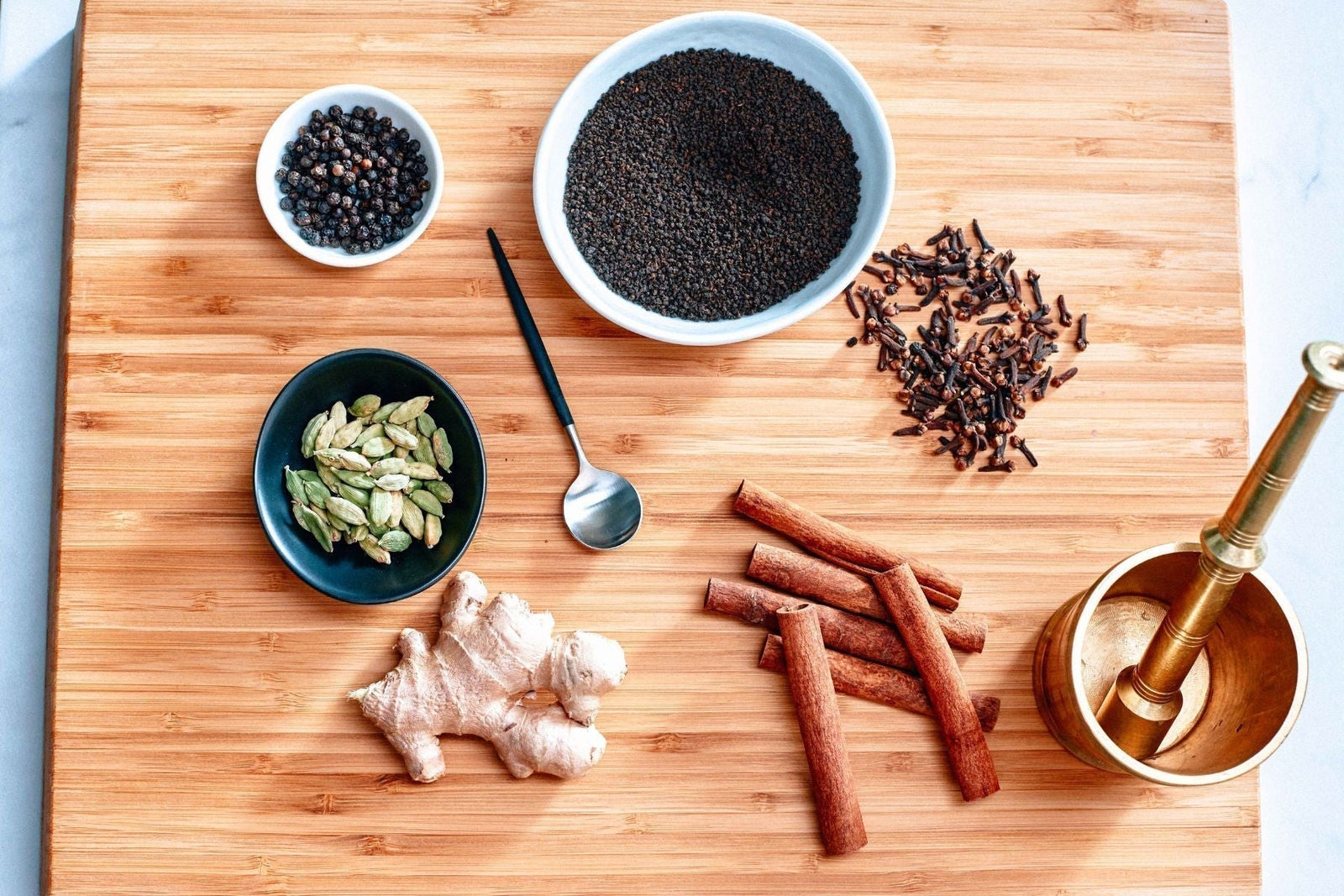 A bowl of Tea India Loose Assam Tea Alongside different spices
