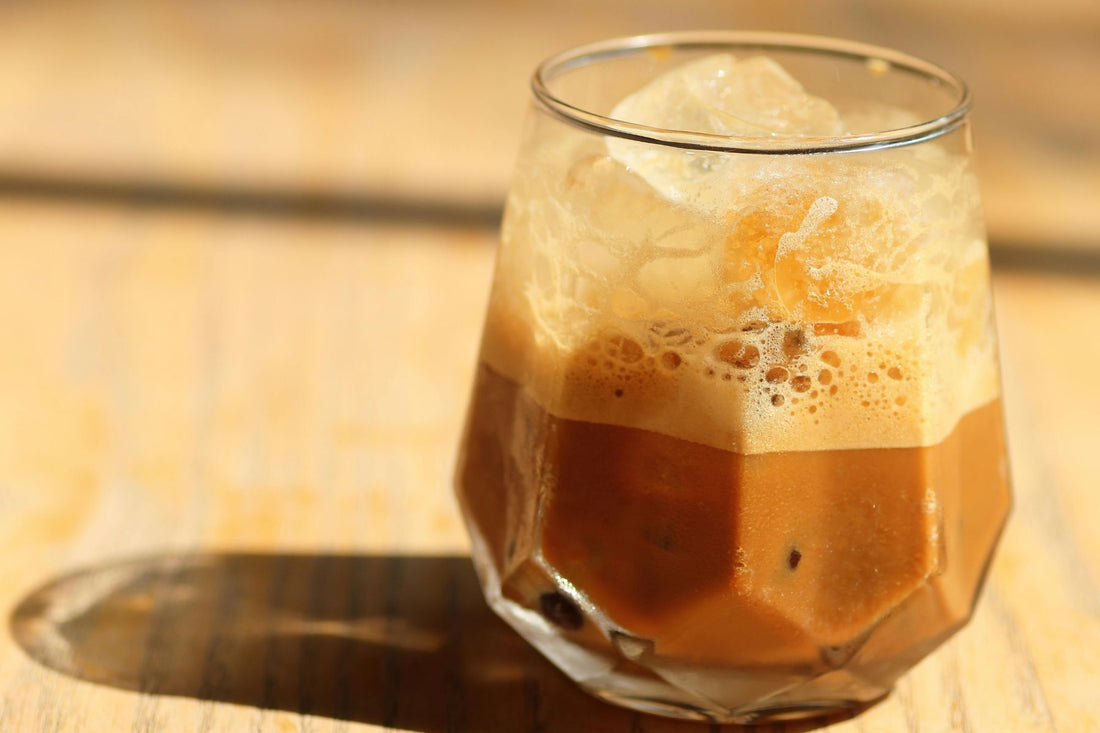 A glass of Iced Saffron Chai Latte on table