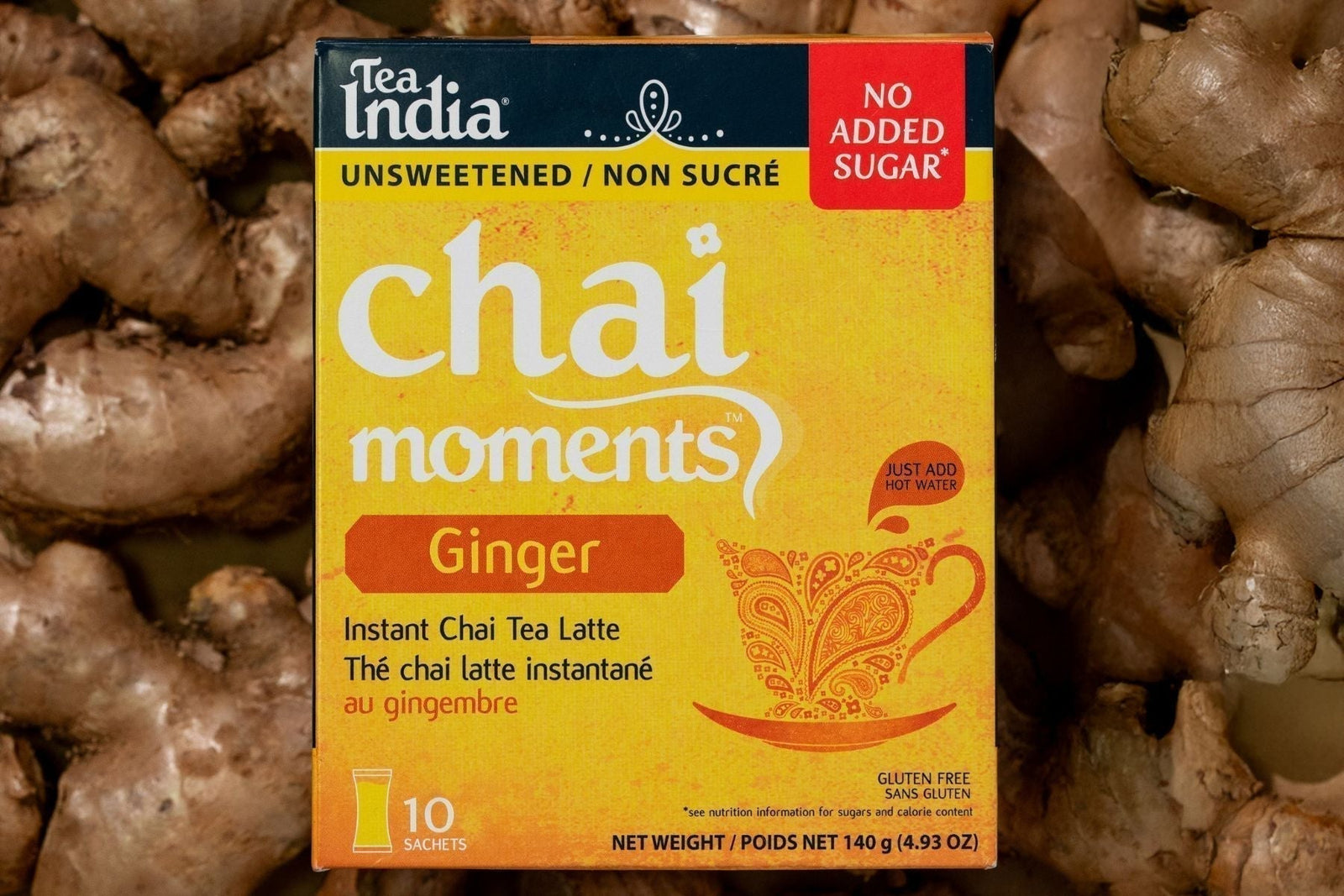 Tea Box containing Ginger Instant Chai Latte kept on a pile of ginger