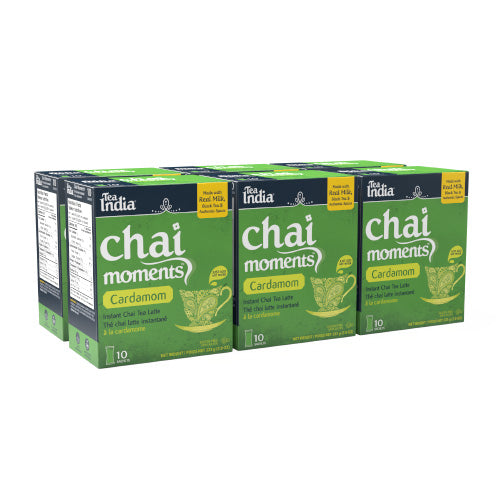 Six boxes of Tea India cardamom chai moments instant latte, each with 10 sachets, arranged in a grouped display