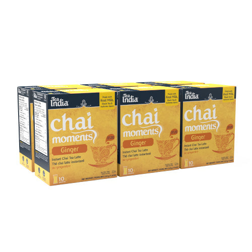 Six boxes of Tea India ginger chai moments instant latte, each with 10 sachets, displayed in a staggered row
