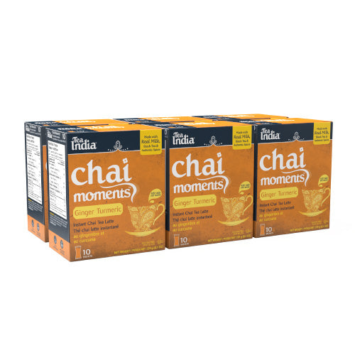 Six boxes of Chai Moments Ginger Turmeric tea from Tata India on a white background