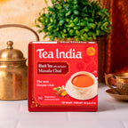 Box of Tea India Masala Chai tea on a table with decorative items in the background