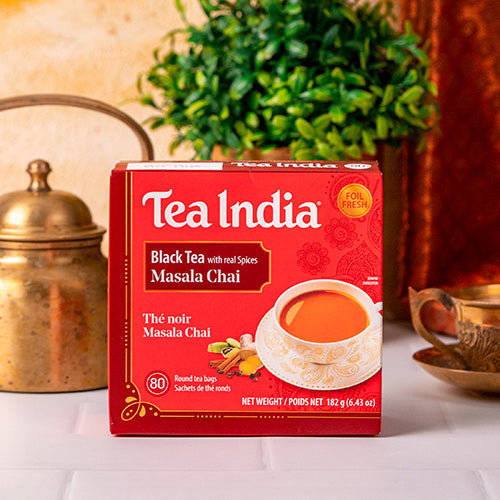 Box of Tea India Masala Chai tea on a table with decorative items in the background
