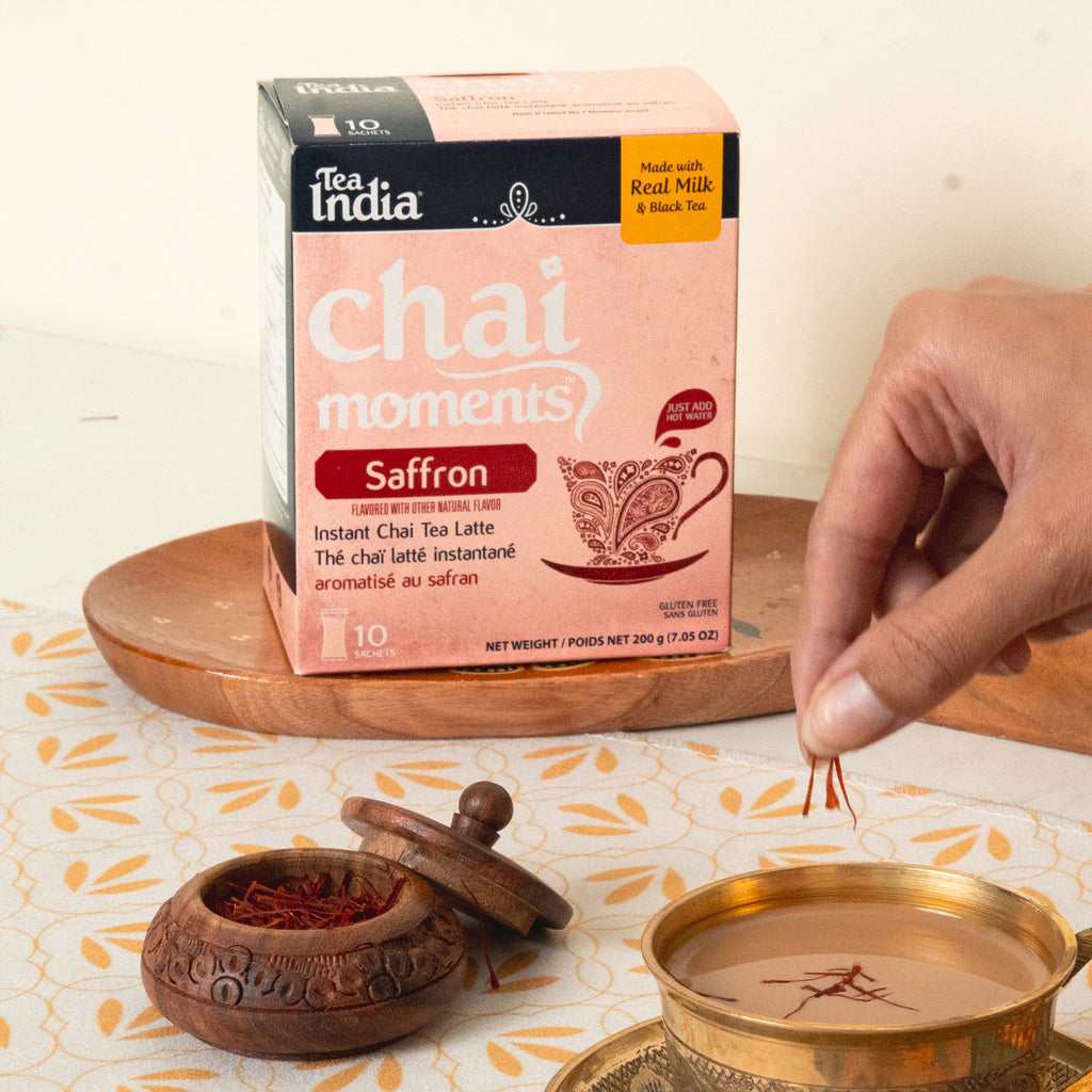 Tea India chai moments saffron instant chai tea latte packaging with a hand adding saffron to a cup.
