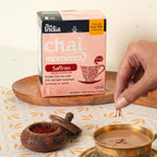 Tea India chai moments saffron instant chai tea latte packaging with a hand adding saffron to a cup.