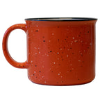 an orange campfire mug with a large handle on a white background