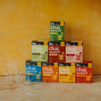 Stack of 'chai moments' tea boxes with a yellow background
