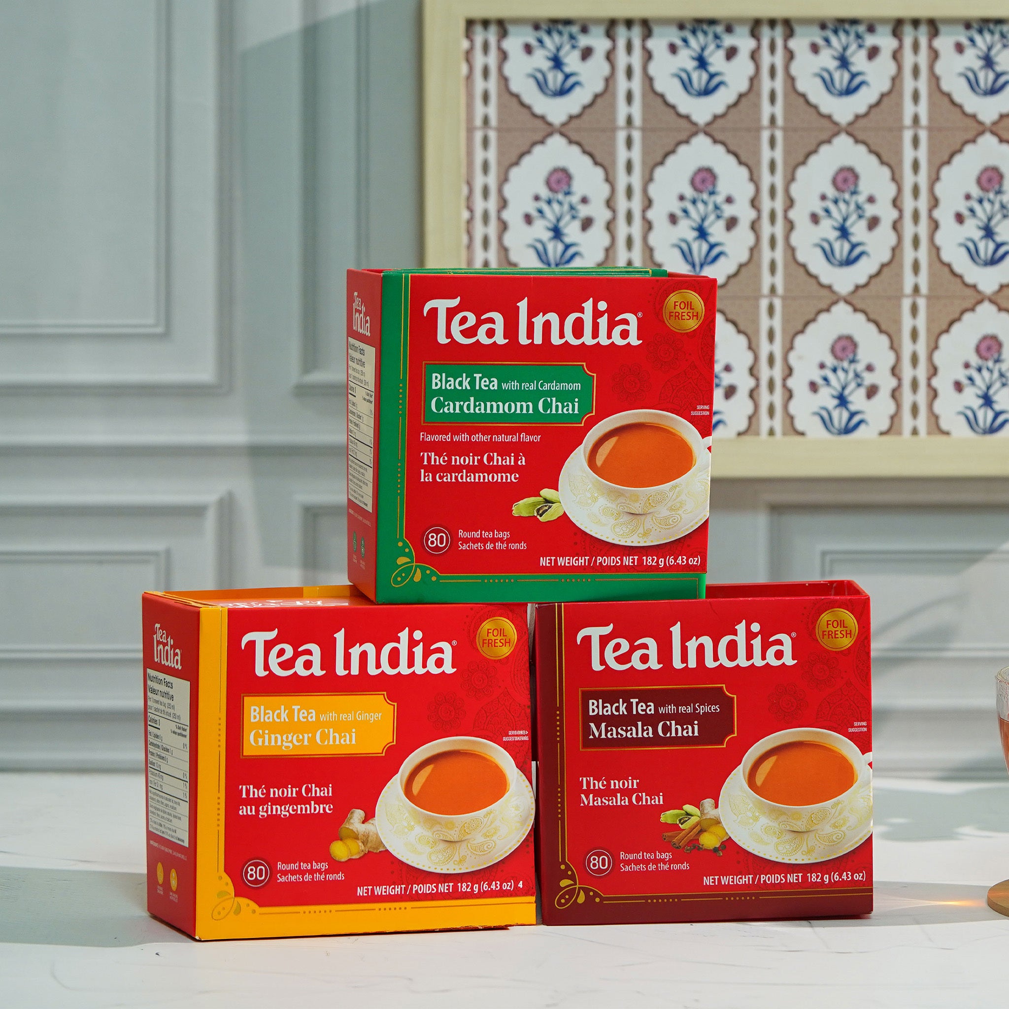 Three boxes of Tea India Chai tea in Masala, Ginger, and Cardamom flavors on a counter