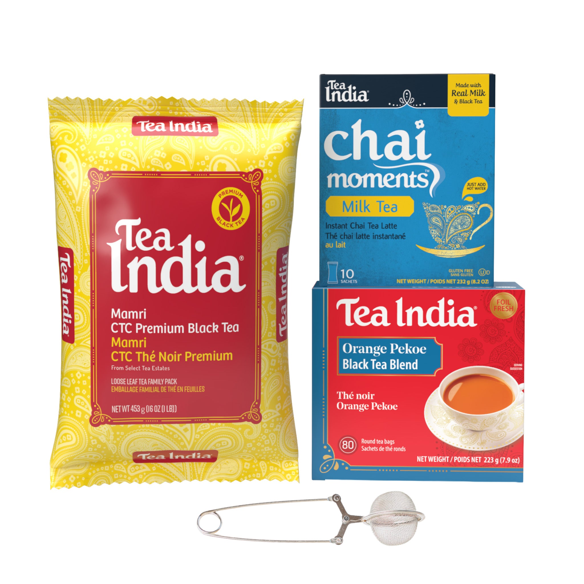 Tea India tea product assortment on a white background, including a large yellow and red Mamri CTC Premium Black Tea bag, a blue Chai Moments Milk Tea box, a red and blue Orange Pekoe Black Tea Blend box, and a metal tea infuser with a ball filter.
