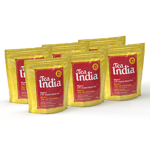 Six pouches of Tea India Mamri CTC Assam Black Tea arranged together, showcasing loose leaf packaging in yellow and red