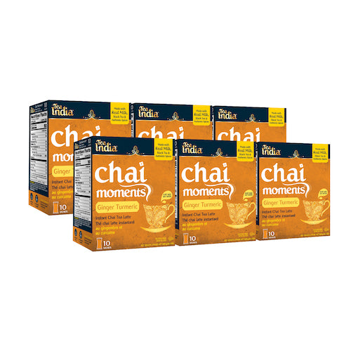 Three boxes and individual sachets of Tea India Chai Moments instant chai latte in Cardamom, Masala, and Ginger flavors