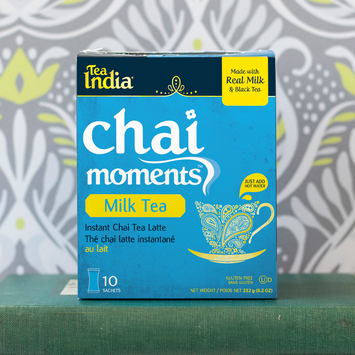 Tea India milk tea chai moments instant latte box placed on a green book with patterned background