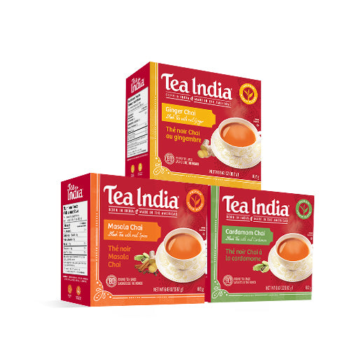 Three Tea India chai boxes featuring ginger, masala, and cardamom flavors stacked with teacups and spice illustrations